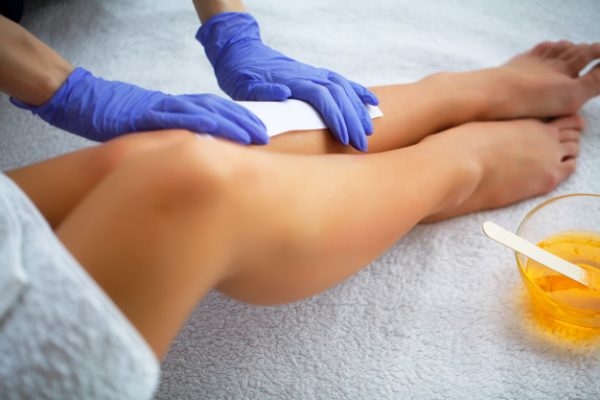 waxing-beautician-waxing-woman-s-leg-spa-salon_118454-5777